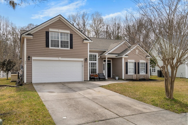 traditional home with a front yard, concrete driveway, a garage, and a shingled roof