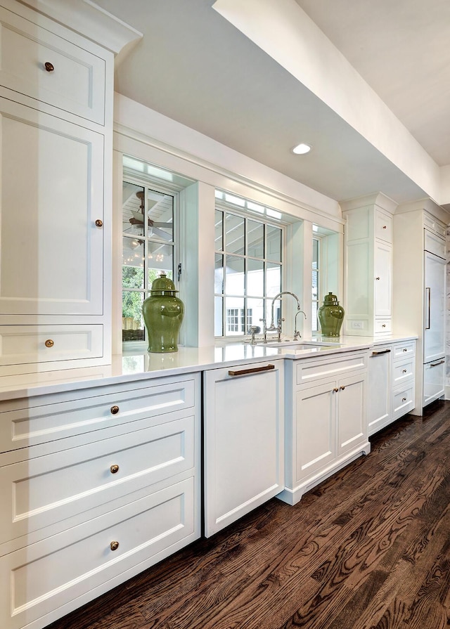 bar with recessed lighting, dark wood-style floors, and a sink