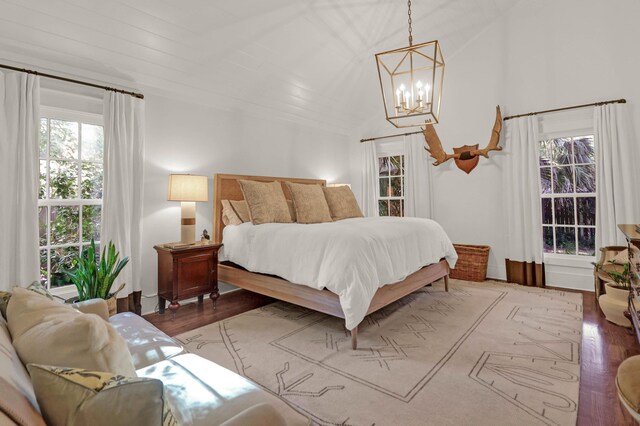 bedroom featuring a notable chandelier and wood finished floors