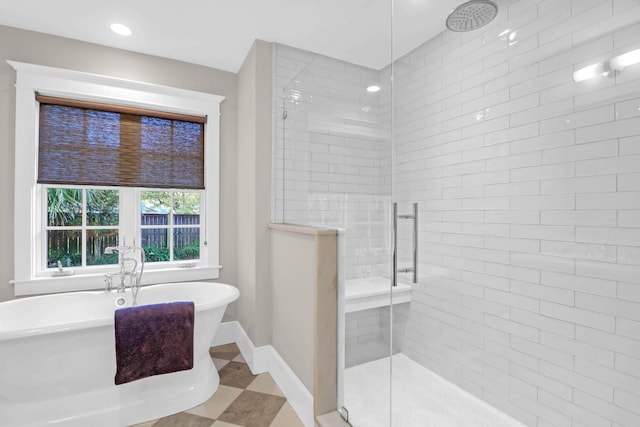 bathroom with recessed lighting, baseboards, a stall shower, and a freestanding bath