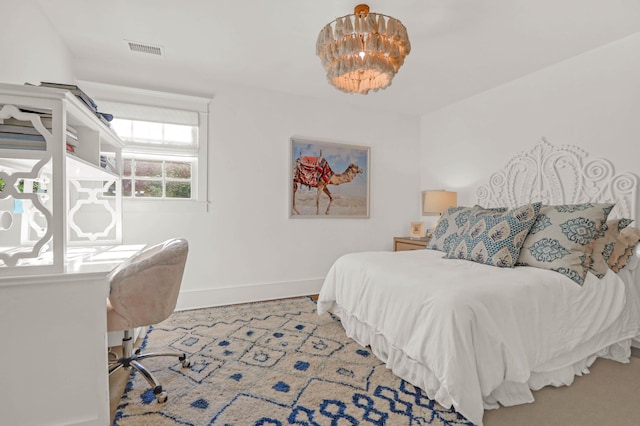 bedroom featuring baseboards and visible vents