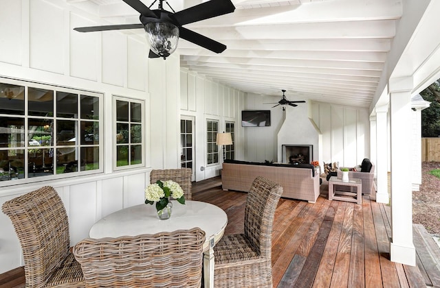sunroom / solarium with lofted ceiling with beams and ceiling fan