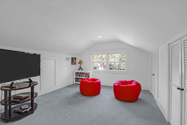 sitting room with lofted ceiling, visible vents, baseboards, and carpet floors