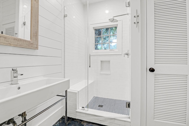 bathroom featuring a shower stall and a sink