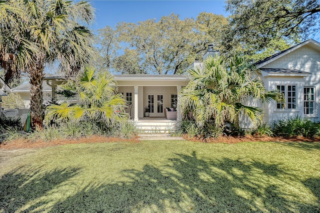 back of house with a yard and french doors