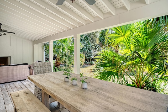 wooden deck featuring outdoor dining space and ceiling fan