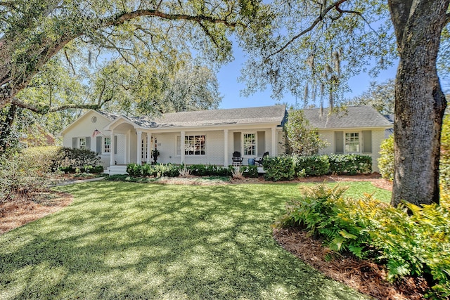 ranch-style house featuring brick siding, a porch, and a front yard