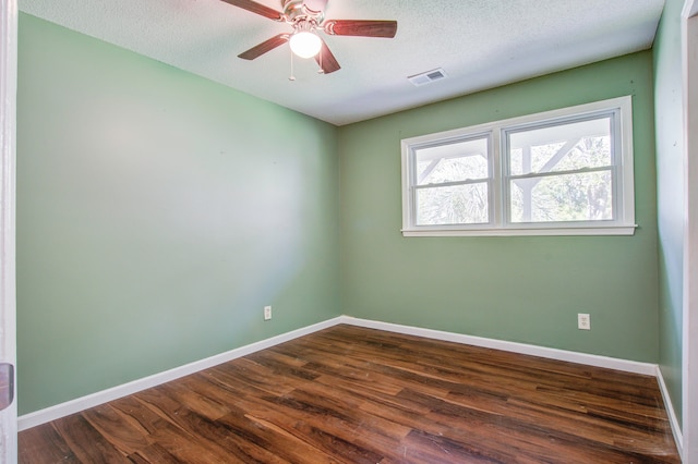 empty room with dark wood-type flooring, ceiling fan, and a textured ceiling