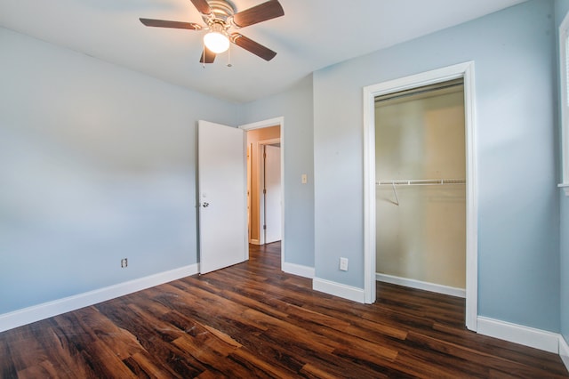 unfurnished bedroom with a closet, dark wood-type flooring, and ceiling fan