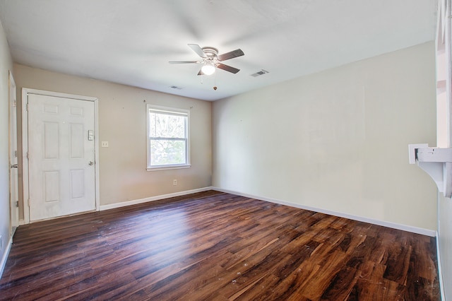 spare room with ceiling fan and dark hardwood / wood-style flooring