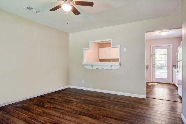 empty room with dark wood-type flooring and ceiling fan