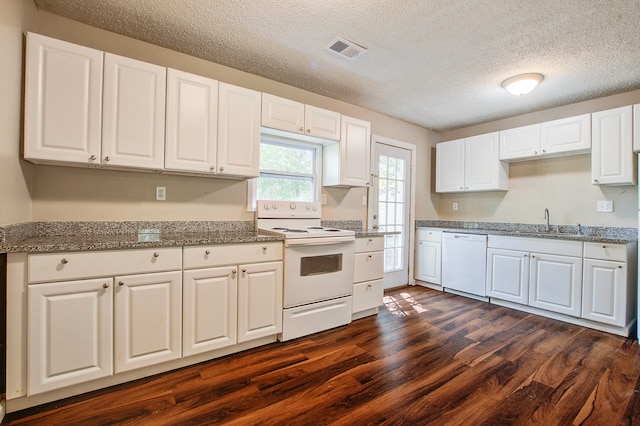 kitchen with white appliances, sink, a textured ceiling, white cabinets, and dark wood-type flooring