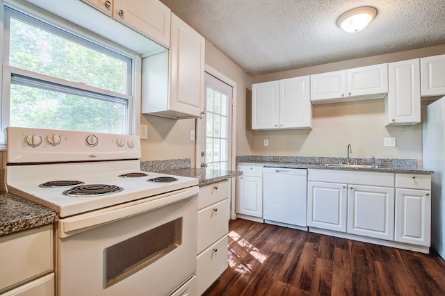 kitchen featuring white appliances, a textured ceiling, dark hardwood / wood-style flooring, and white cabinets