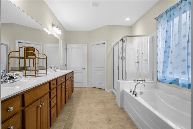 bathroom with plus walk in shower, vanity, and tile patterned floors