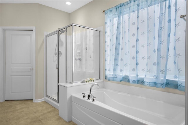 bathroom with tile patterned flooring and separate shower and tub