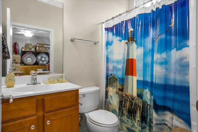 bathroom with ceiling fan, vanity, a shower with shower curtain, and toilet