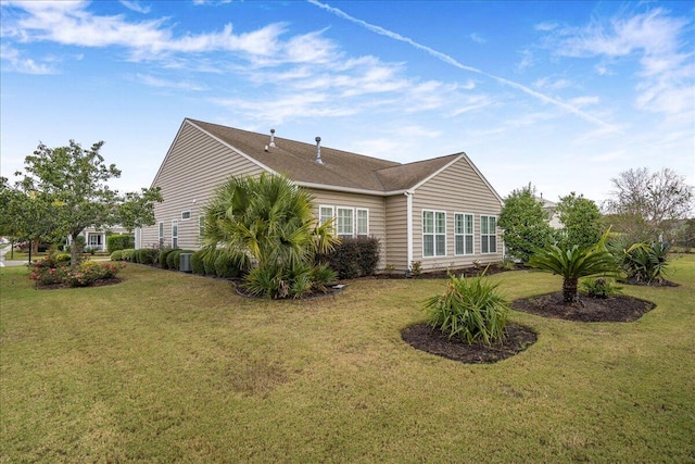 view of side of home featuring a yard