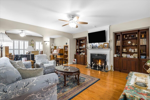 living room featuring ceiling fan and light hardwood / wood-style flooring