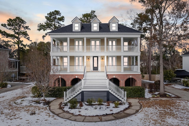 view of front facade with a balcony and a porch