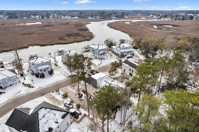 snowy aerial view featuring a water view