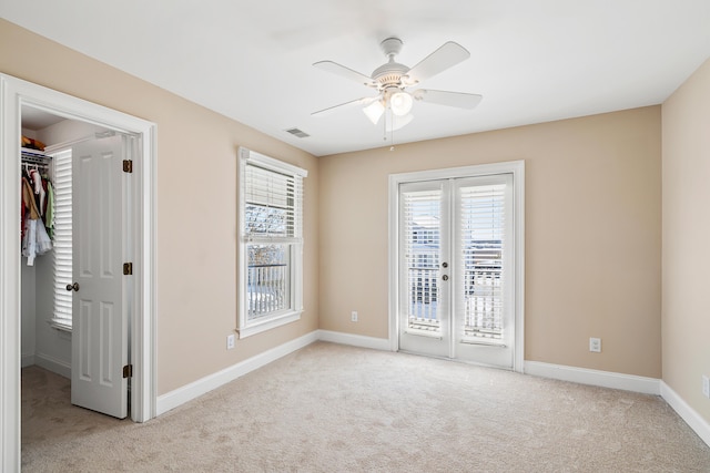 unfurnished bedroom with french doors, light colored carpet, access to exterior, ceiling fan, and a closet