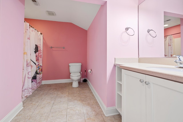 bathroom featuring vanity, lofted ceiling, and toilet