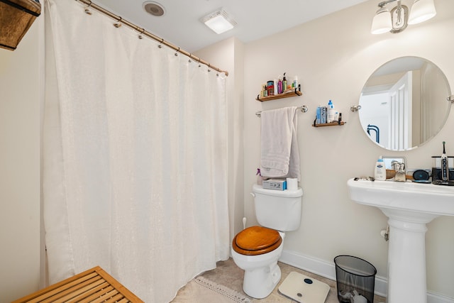 bathroom featuring tile patterned floors and toilet