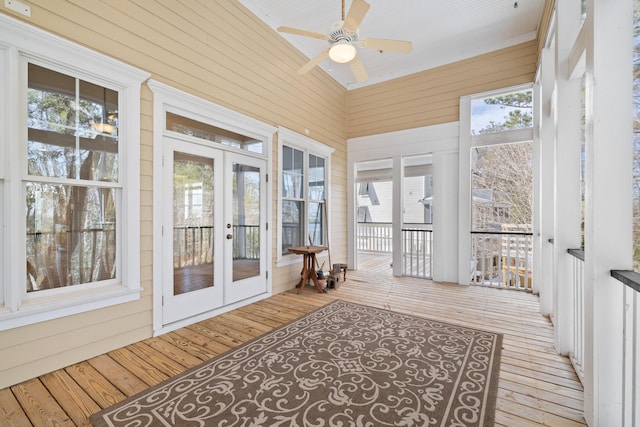 sunroom featuring ceiling fan and french doors