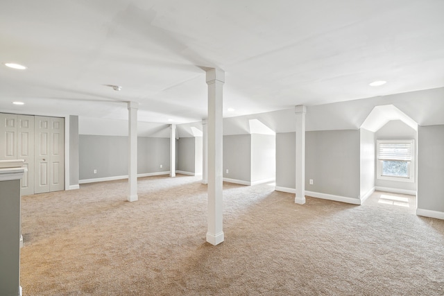 basement featuring light colored carpet