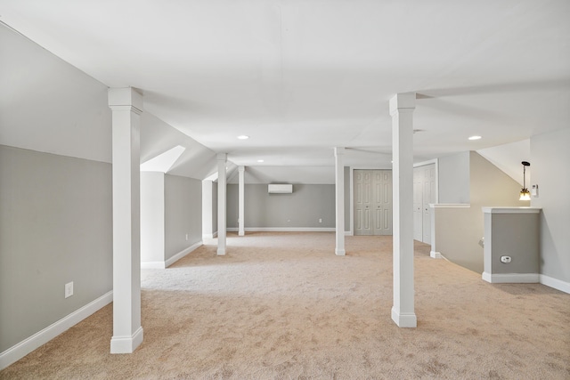 basement featuring light colored carpet and an AC wall unit