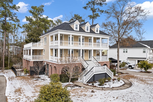 view of front of house with a balcony and covered porch