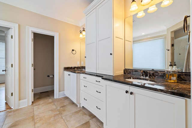 bathroom with crown molding, vanity, and a shower with door