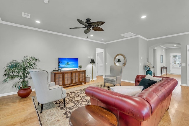 living room with ceiling fan, light hardwood / wood-style flooring, and ornamental molding