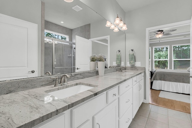 bathroom featuring vanity, tile patterned flooring, a shower with shower door, and ceiling fan