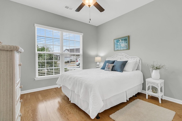 bedroom with ceiling fan and wood-type flooring