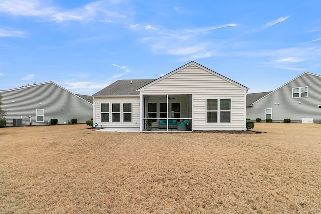 back of property featuring a patio area, central air condition unit, a yard, ceiling fan, and a sunroom