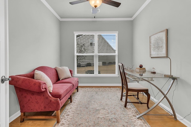 office with ceiling fan, crown molding, and light hardwood / wood-style floors