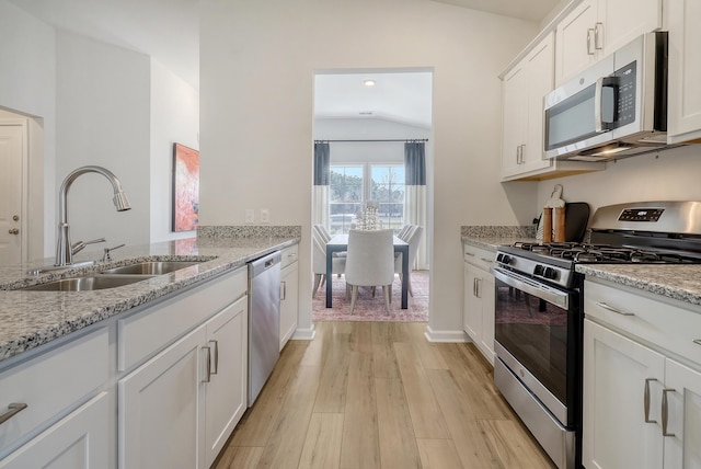 TBD Oleary Cir, Summerville, SC 29483 - kitchen with light wood-type flooring, stainless steel appliances, a sink, white cabinets, and light stone countertops
