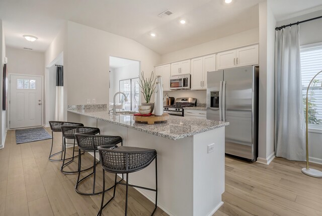TBD Oleary Cir, Summerville, SC 29483 - kitchen with a healthy amount of sunlight, a breakfast bar, a sink, visible vents, and appliances with stainless steel finishes