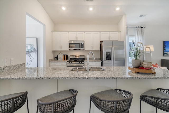 TBD Oleary Cir, Summerville, SC 29483 - kitchen featuring a sink, white cabinetry, a kitchen bar, and appliances with stainless steel finishes