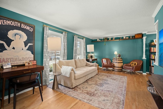 interior space featuring a textured ceiling, wood finished floors, and crown molding