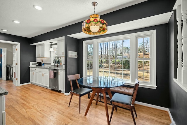 dining room featuring light wood finished floors, baseboards, washer and clothes dryer, recessed lighting, and a textured ceiling