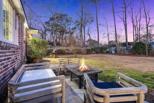 view of patio with a fire pit and fence