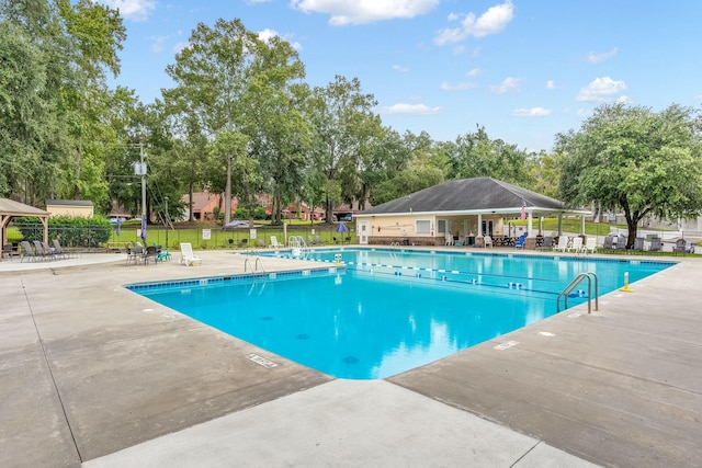 pool featuring a gazebo, fence, and a patio area