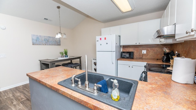 2186 Spoleto Ln, North Charleston, SC 29406 - kitchen with freestanding refrigerator, range hood, wood finished floors, decorative light fixtures, and white cabinetry
