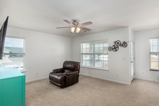 living area featuring visible vents, a ceiling fan, baseboards, and carpet floors