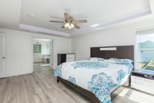 bedroom with a ceiling fan, a raised ceiling, wood finished floors, and ornamental molding