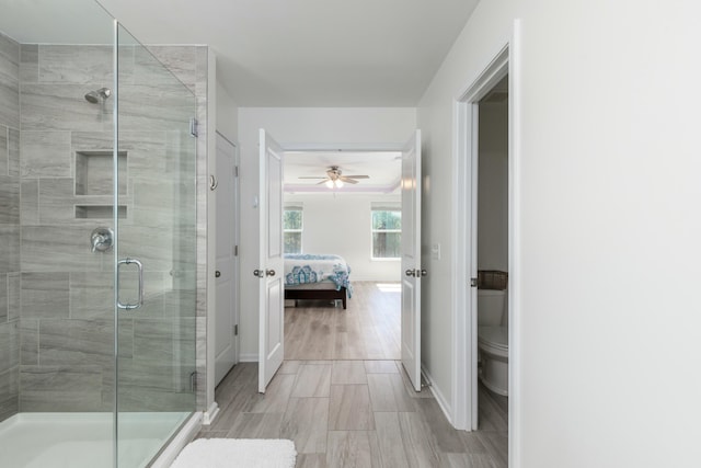 full bathroom with baseboards, toilet, ensuite bath, and a stall shower