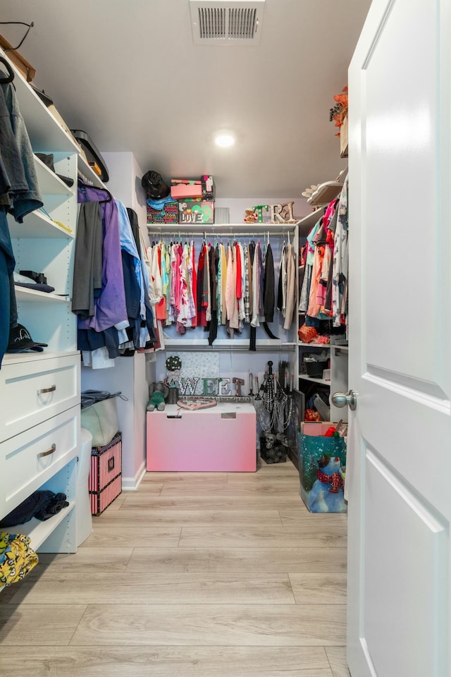 spacious closet featuring visible vents and wood finished floors