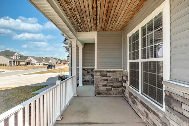 balcony with covered porch and a residential view